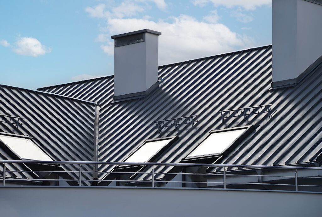 what are the most durable roofing materials Close-up house retro roof panel with standing seam and fasteners. Classic style black metal panel with rebate joint. Modern galvanized steel roofing sheet with ribs. . Building's covering