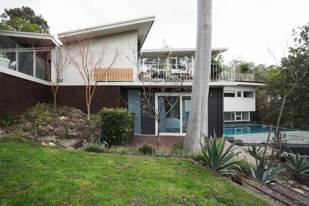 roof types Exterior of a large mid century modern home with pool and landscaped garden